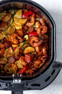 This fast and easy Air Fryer Cajun Shrimp recipe is a meal-in-one, made with shrimp, sausage, and lots of colorful vegetables such as zucchini, yellow squash and bell peppers.