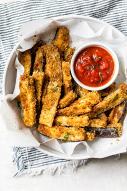 These Baked Eggplant Sticks are breaded with Italian breadcrumbs and Parmesan, baked or air-fried until golden, and served with a quick marinara sauce.