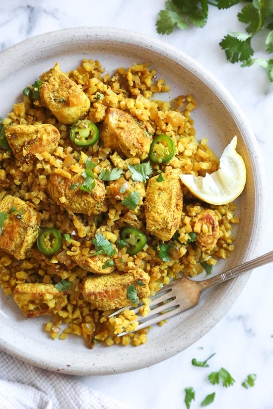 This quick and easy Indian-inspired skillet dish, is a low-carb take on Chicken Biryani, made with riced cauliflower in place of rice. It's also Keto, gluten-free and Whole30 compliant.