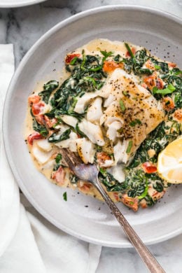 This easy Fish Florentine recipe, made with a pan seared firm white fish served on a creamy bed of spinach feels like something you would order out in a fancy restaurant!