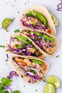 These easy Cilantro Lime Fish Tacos are made with flaky white fish, tomatoes, jalapeños, cilantro and lime topped with avocado.