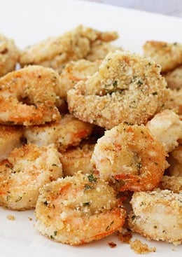 Breaded shrimp on a plate served with lemons