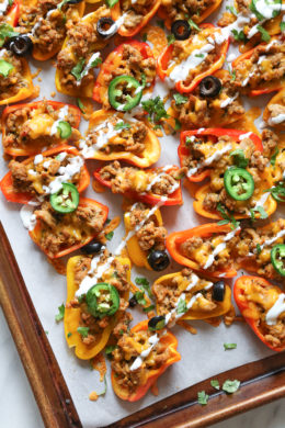 Loaded mini bell pepper nachos – game changer!! These low-carb nachos are loaded with turkey taco meat, cheese and all your favorite nacho toppings!